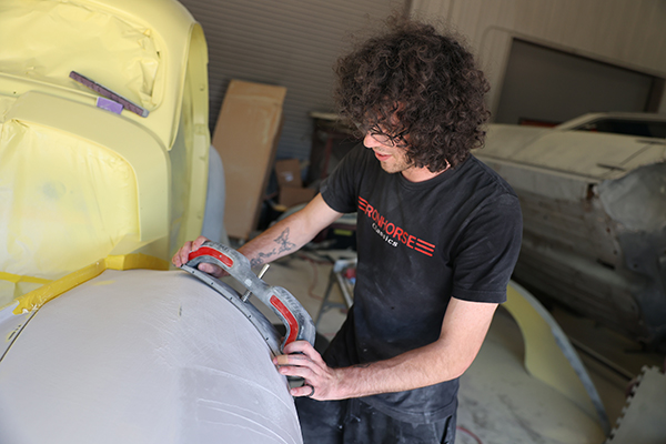 Paint and Body - Expert sanding a car, prepping for paint